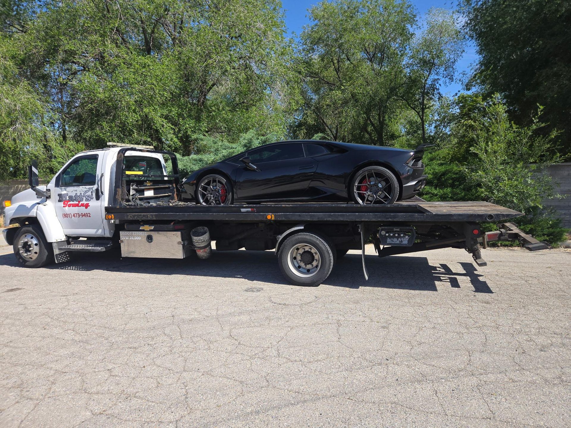 Black Lamborghini on an Apex Collision flatbed